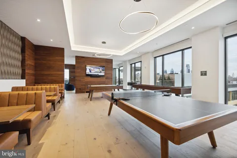 a living room with furniture large window and a fireplace