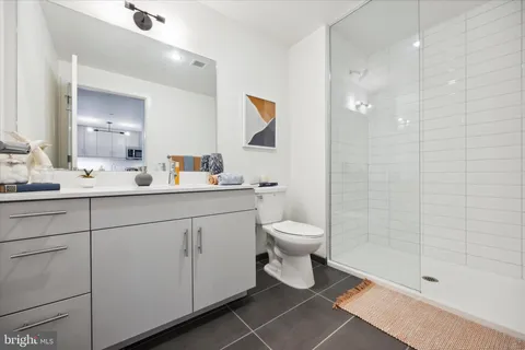 a bathroom with a toilet sink and shower