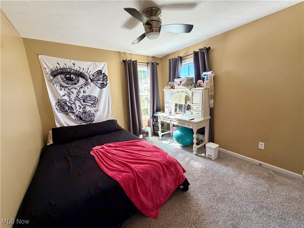 7374 Virginia Road Atwater, OH 44201 - Photo 34 of 49 Bedroom with carpet floors, a ceiling fan, and a textured ceiling