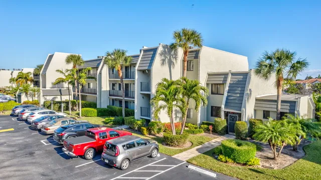 a front view of multiple houses with yard