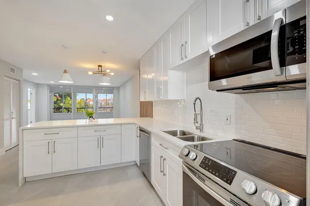 a kitchen with a sink stainless steel appliances and cabinets