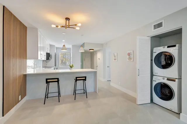 a kitchen with kitchen island cabinets and refrigerator