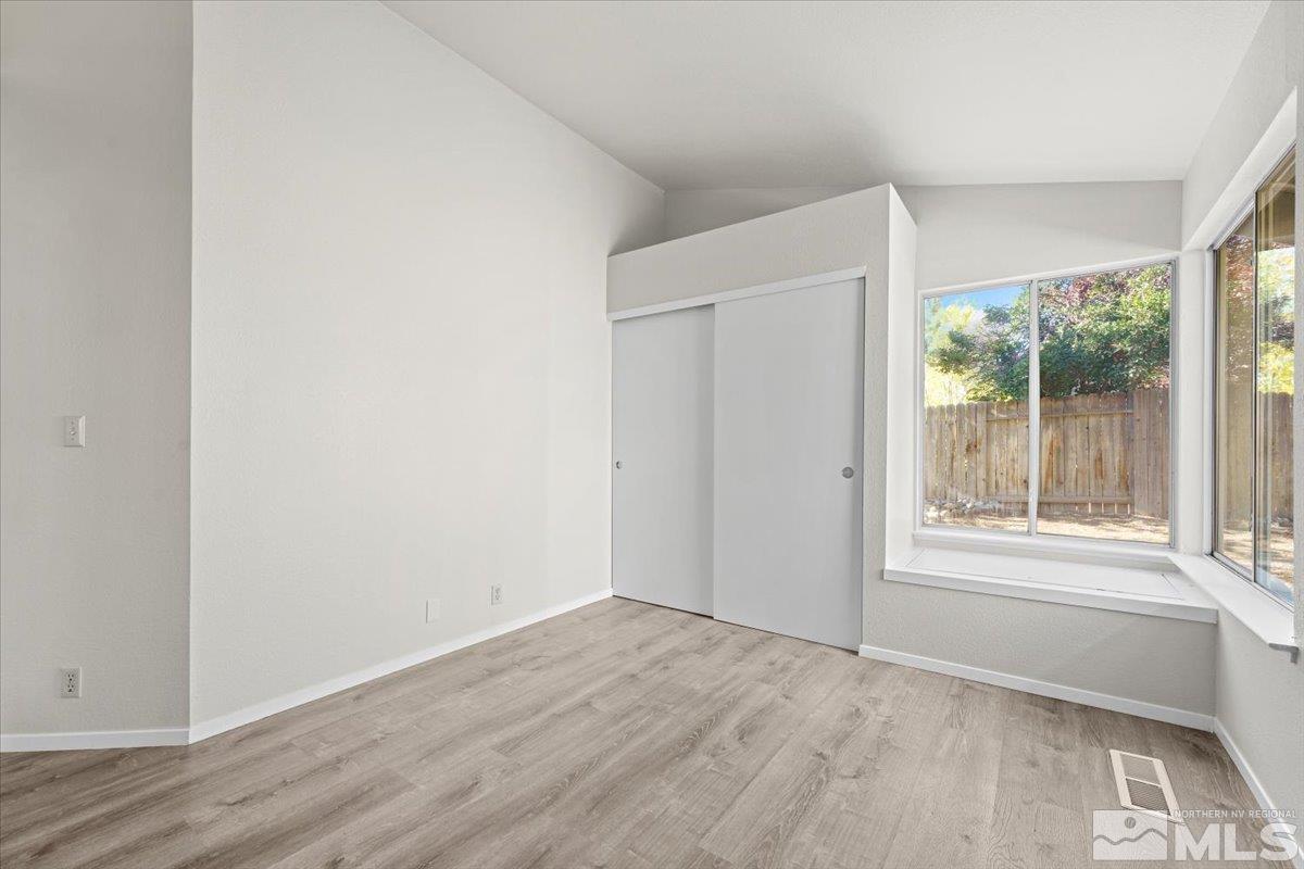 5154 Aspen View Drive Reno, NV 89523 - Photo 16 of 23 an empty room with wooden floor and windows