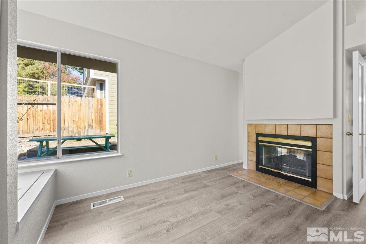 5154 Aspen View Drive Reno, NV 89523 - Photo 17 of 23 a view of an empty room with a fireplace and a window