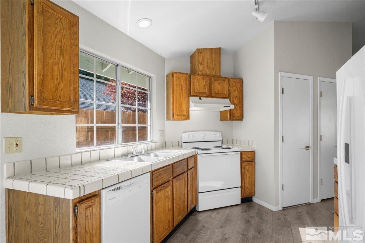5154 Aspen View Drive Reno, NV 89523 - Photo 6 of 23 a kitchen with a sink stove and cabinets