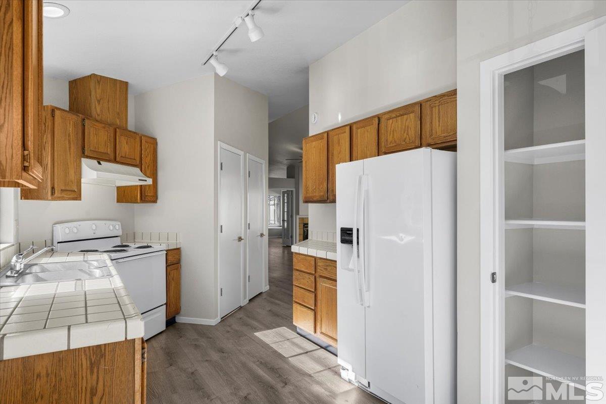 5154 Aspen View Drive Reno, NV 89523 - Photo 7 of 23 a white refrigerator freezer sitting inside of a kitchen
