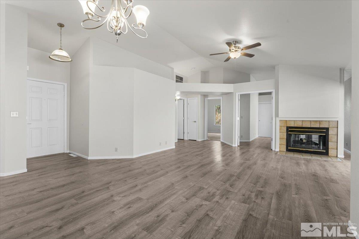 5154 Aspen View Drive Reno, NV 89523 - Photo 9 of 23 a view of a livingroom with a fireplace a chandelier and wooden floor