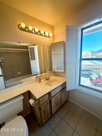 an empty room with windows and ceiling fan view