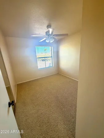 a view of a room with a mirror and a fan