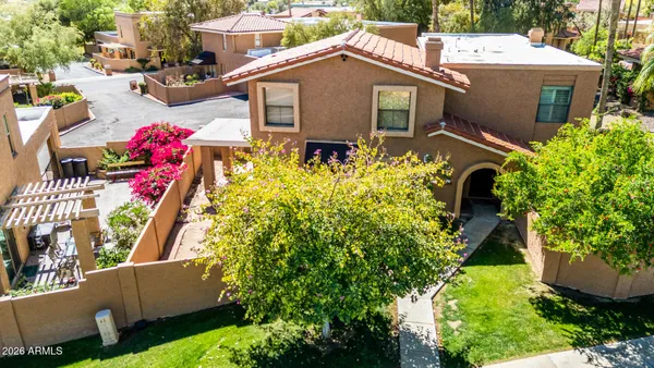 an aerial view of a house with swimming pool and garden