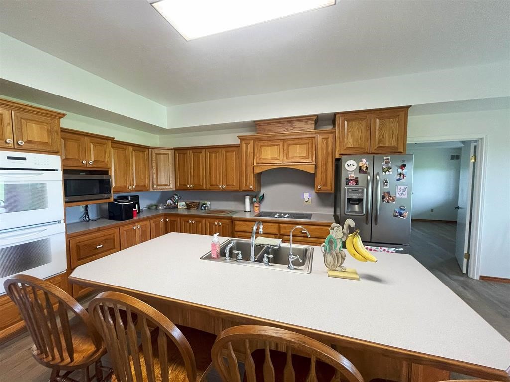 13979 Shellhammer Road Winnie, TX 77665 - Photo 11 of 47 a kitchen with stainless steel appliances granite countertop a sink a stove and a refrigerator