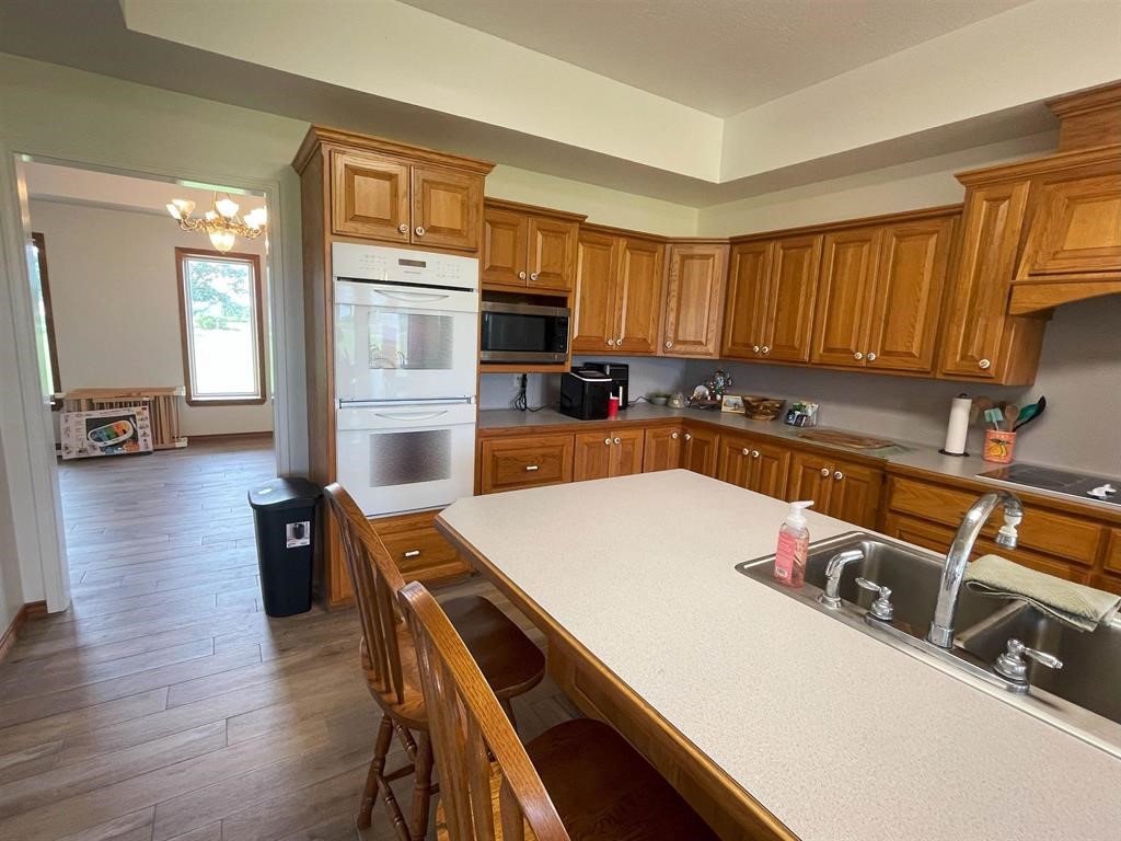 13979 Shellhammer Road Winnie, TX 77665 - Photo 13 of 47 a kitchen with a table chairs refrigerator and microwave