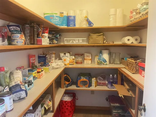 a view of a room with wooden floor and furniture