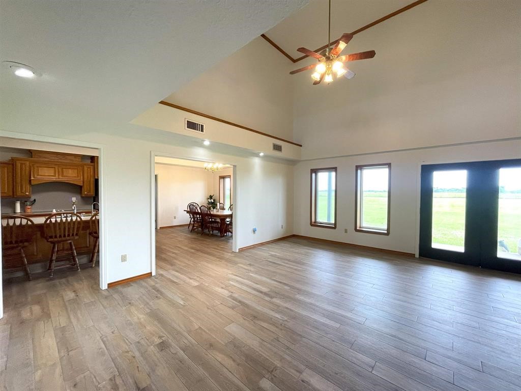 13979 Shellhammer Road Winnie, TX 77665 - Photo 19 of 47 a view of livingroom with hardwood floor and a ceiling fan