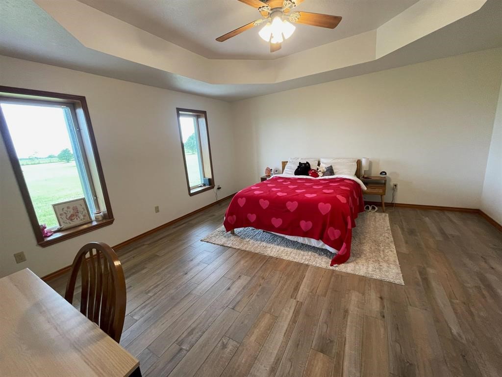 13979 Shellhammer Road Winnie, TX 77665 - Photo 25 of 47 a view of a room with wooden floor and chandelier