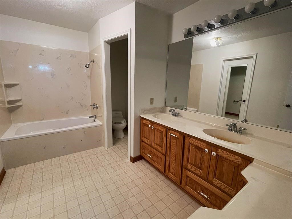 13979 Shellhammer Road Winnie, TX 77665 - Photo 28 of 47 a spacious bathroom with a tub sink double and mirror