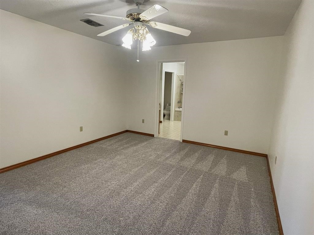 13979 Shellhammer Road Winnie, TX 77665 - Photo 30 of 47 an empty room with chandelier fan