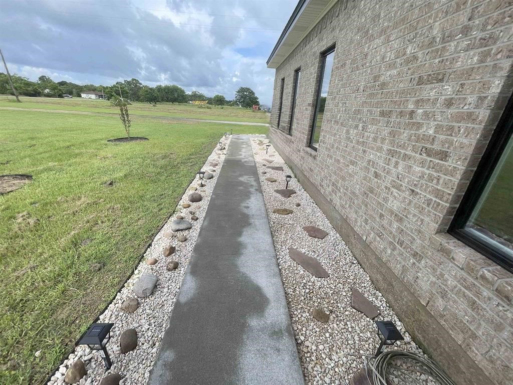 13979 Shellhammer Road Winnie, TX 77665 - Photo 3 of 47 a view of a pathway with a yard