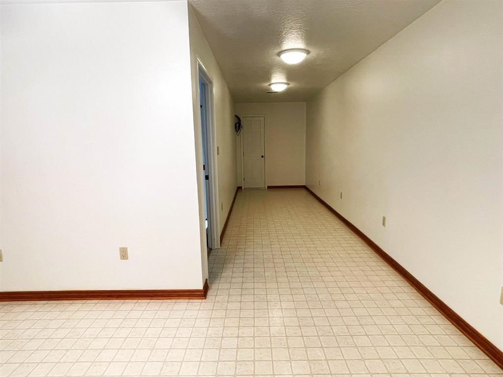 13979 Shellhammer Road Winnie, TX 77665 - Photo 32 of 47 an empty room with wooden floor