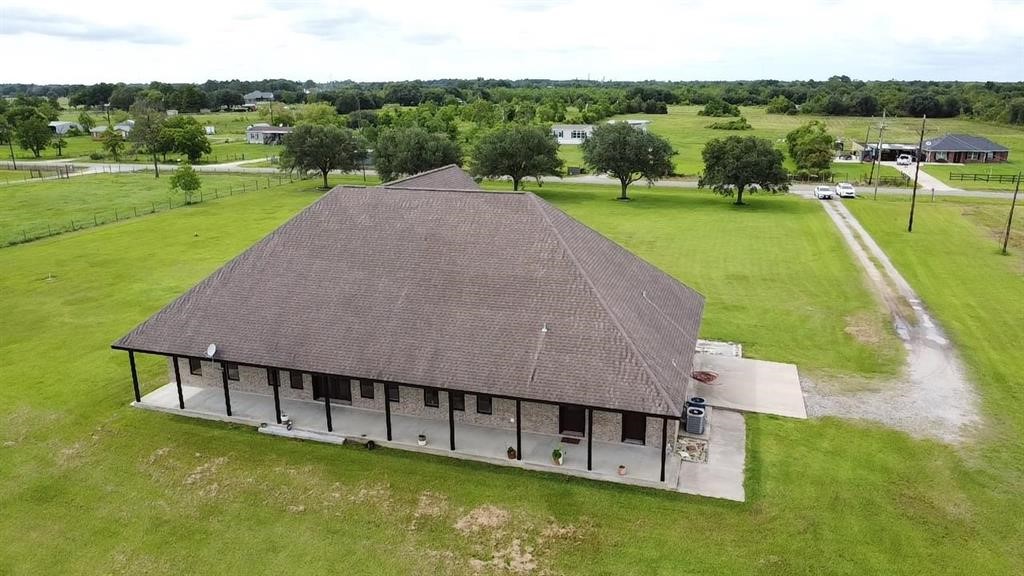 13979 Shellhammer Road Winnie, TX 77665 - Photo 5 of 47 an aerial view of a house with swimming pool and green yard