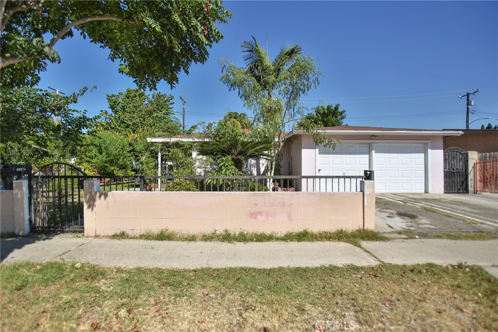 2525 West 10th Street Santa Ana, CA 92703 - Photo 1 of 37 a house with palm tree in front of it