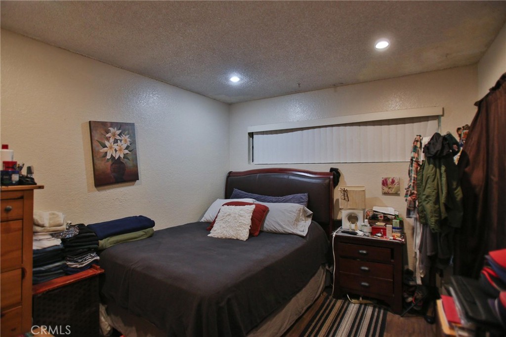 2525 West 10th Street Santa Ana, CA 92703 - Photo 16 of 37 a bedroom with a bed and a walk in closet