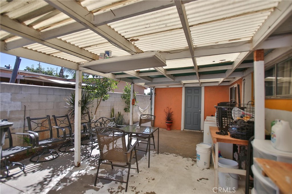 2525 West 10th Street Santa Ana, CA 92703 - Photo 19 of 37 a view of a patio with table and chairs and potted plants