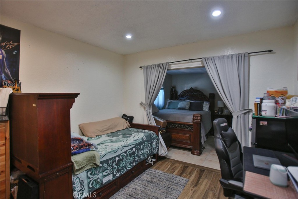 2525 West 10th Street Santa Ana, CA 92703 - Photo 23 of 37 a bedroom with a bed and wooden floor