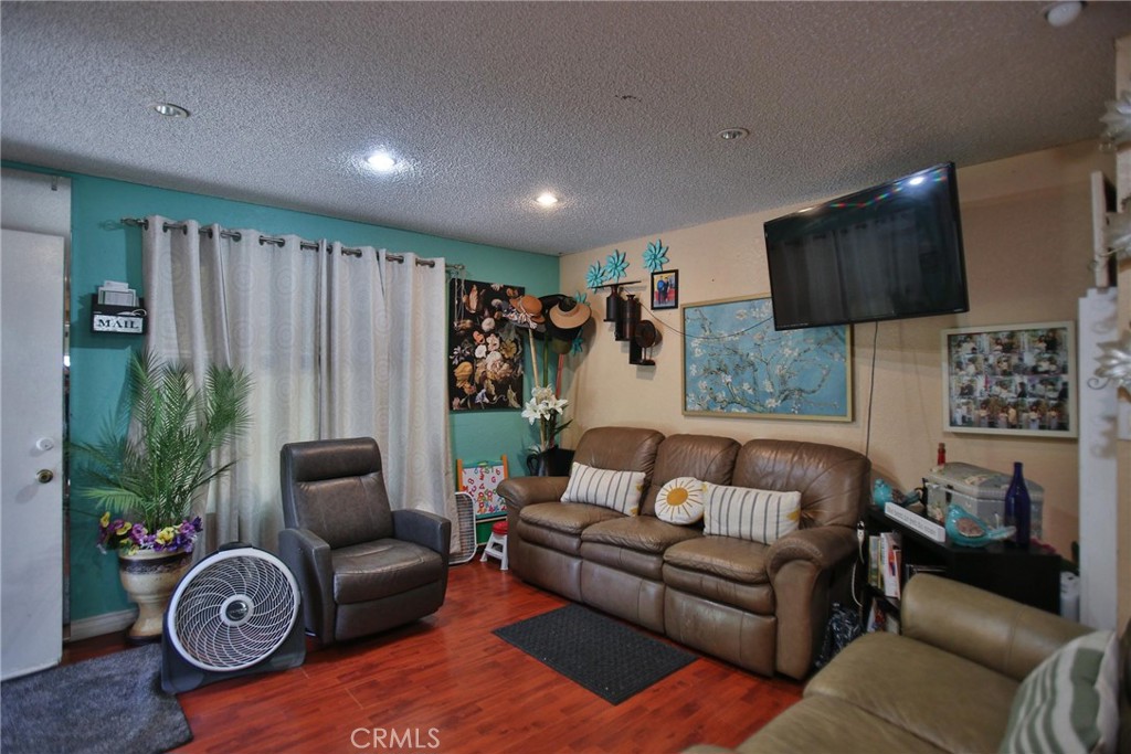 2525 West 10th Street Santa Ana, CA 92703 - Photo 24 of 37 a living room with furniture and a flat screen tv