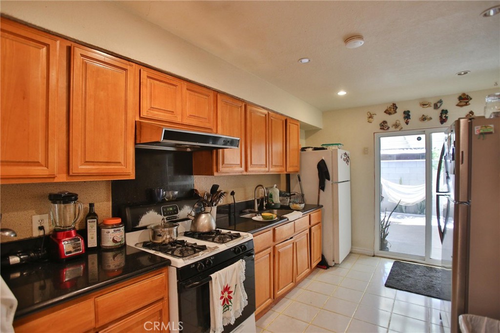 2525 West 10th Street Santa Ana, CA 92703 - Photo 32 of 37 a kitchen with stainless steel appliances granite countertop a sink stove and refrigerator