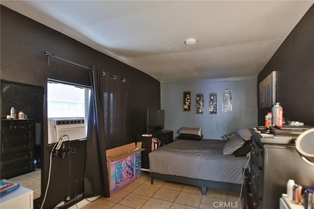 2525 West 10th Street Santa Ana, CA 92703 - Photo 37 of 37 a bedroom with a bed and wooden floor