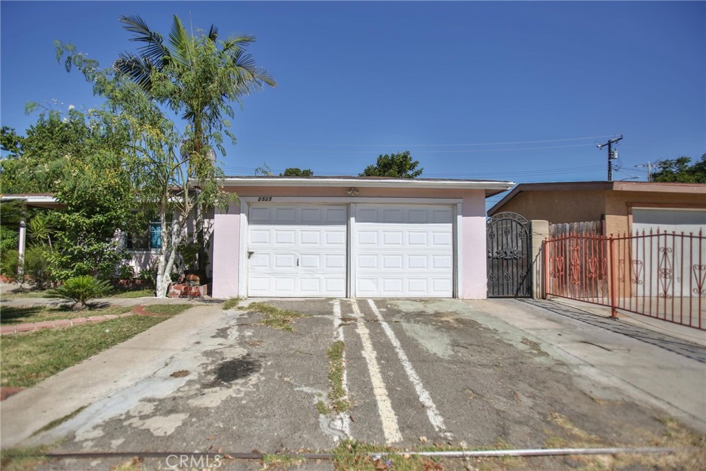 2525 West 10th Street Santa Ana, CA 92703 - Photo 6 of 37 a front view of a house with a yard and garage