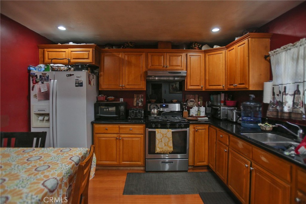 2525 West 10th Street Santa Ana, CA 92703 - Photo 10 of 37 a kitchen with granite countertop a refrigerator and a sink