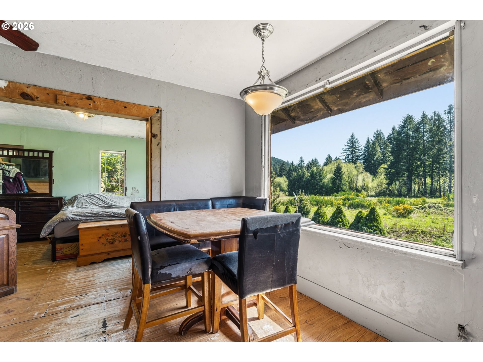 21542 Highway 126 Noti, OR 97461 - Photo 12 of 22 a view of a dining room with furniture window and wooden floor