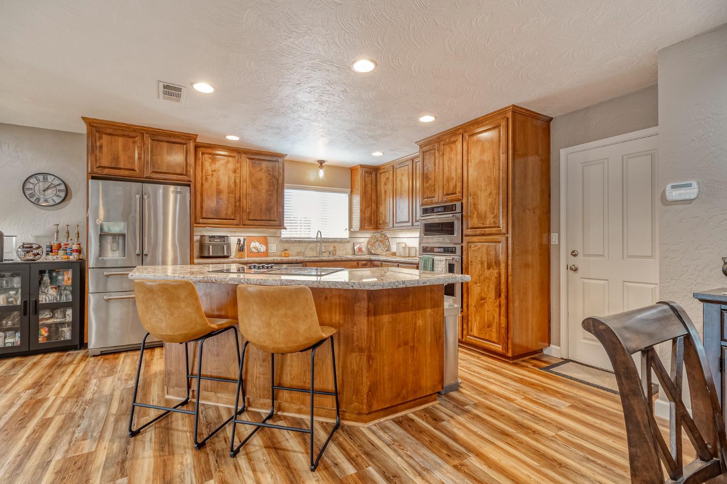 1512 Kruger Drive Modesto, CA 95355 - Photo 12 of 33 a kitchen with stainless steel appliances granite countertop a refrigerator and a stove top oven