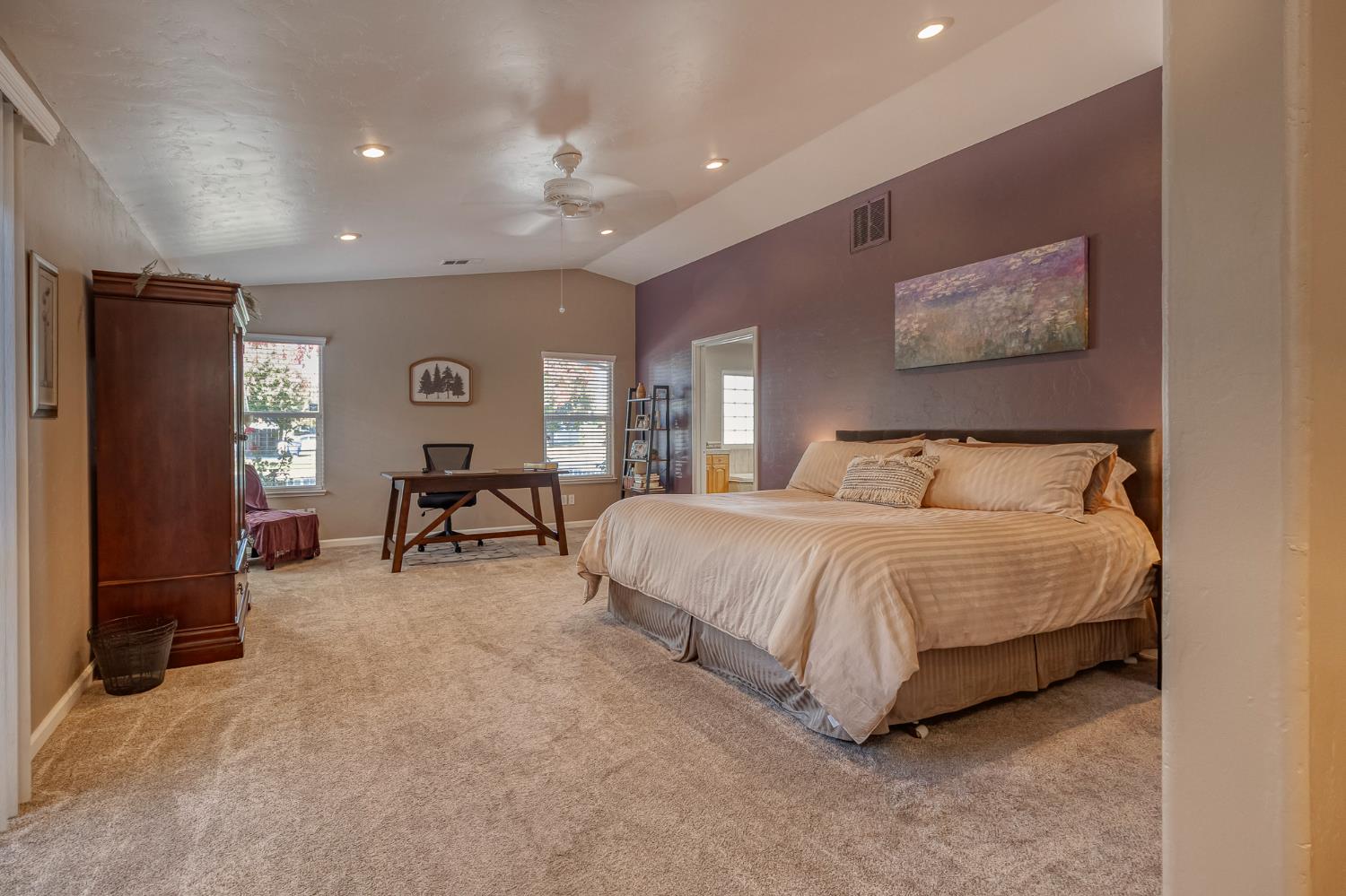 1512 Kruger Drive Modesto, CA 95355 - Photo 27 of 33 a spacious bedroom with a bed a couch and a bookshelf