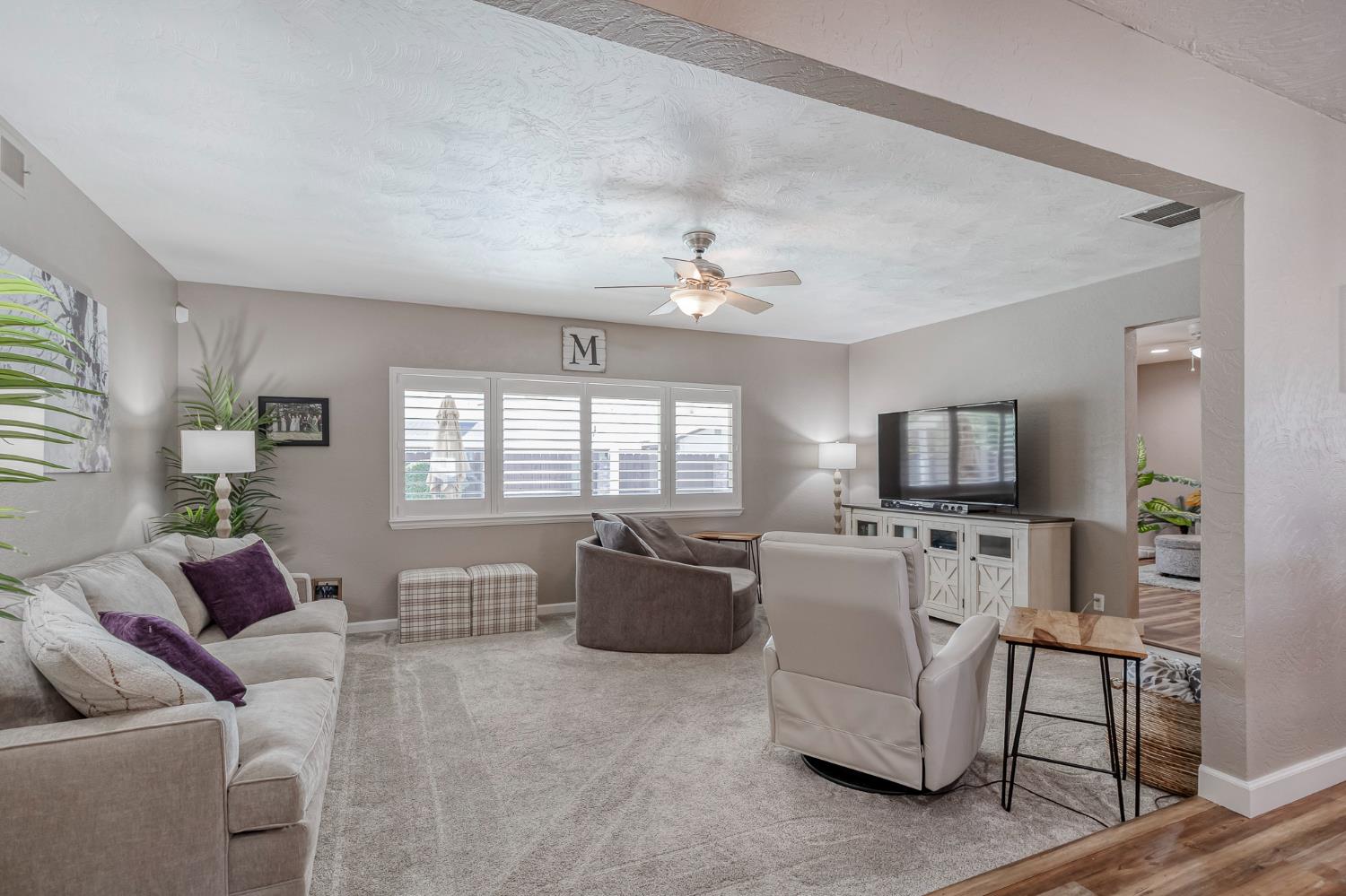 1512 Kruger Drive Modesto, CA 95355 - Photo 6 of 33 a living room with furniture a flat screen tv and a window