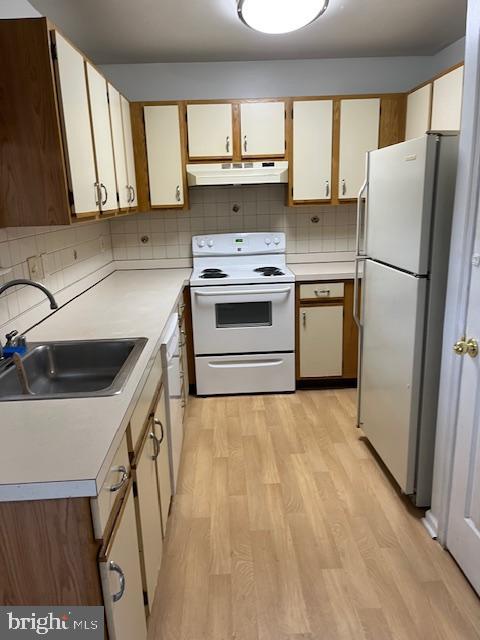 a kitchen with a stove a refrigerator and a sink