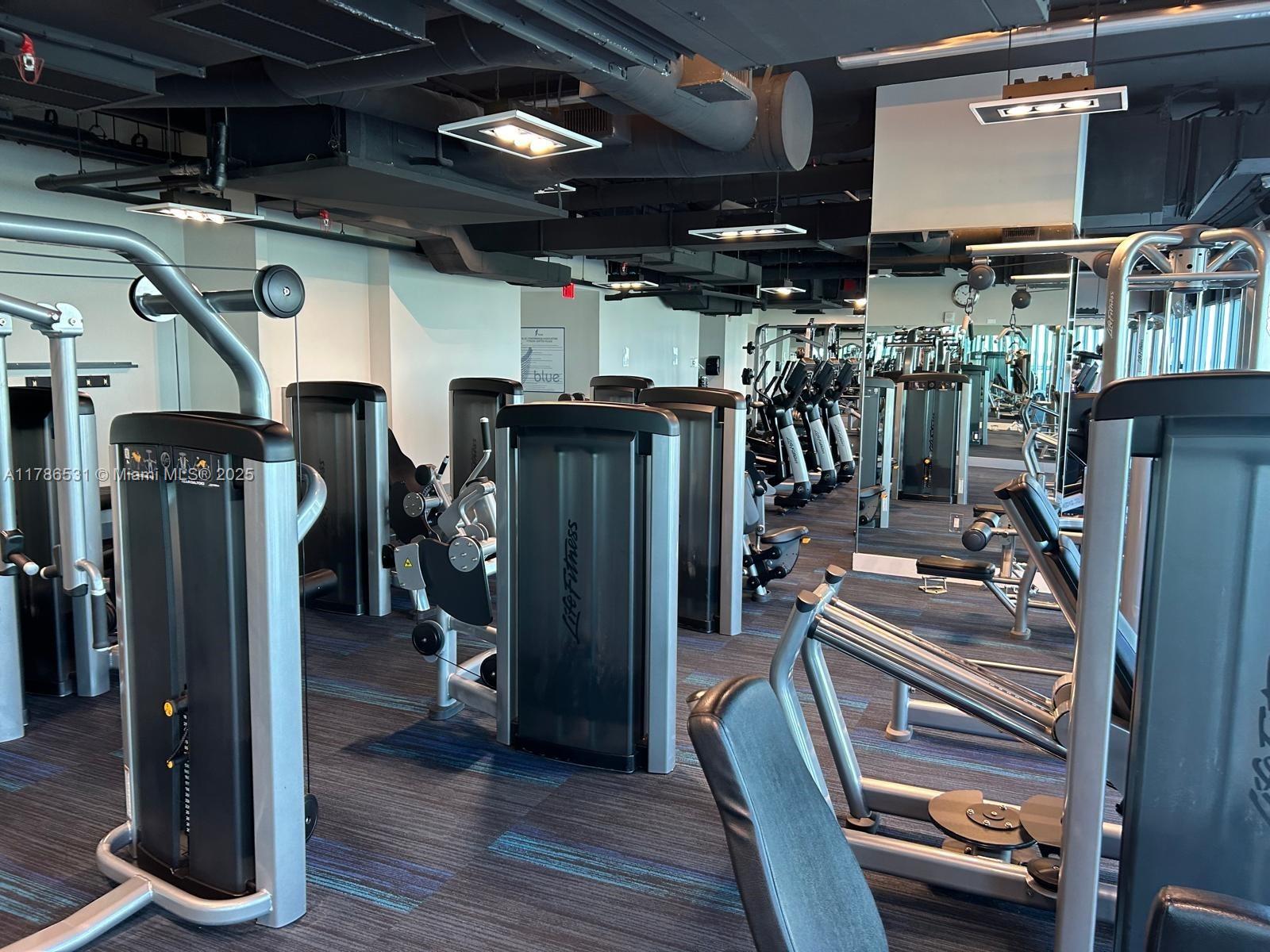 601 Northeast 36th Street, Unit 801 Miami, FL 33137 - Photo 13 of 24 a view of a room with gym equipment