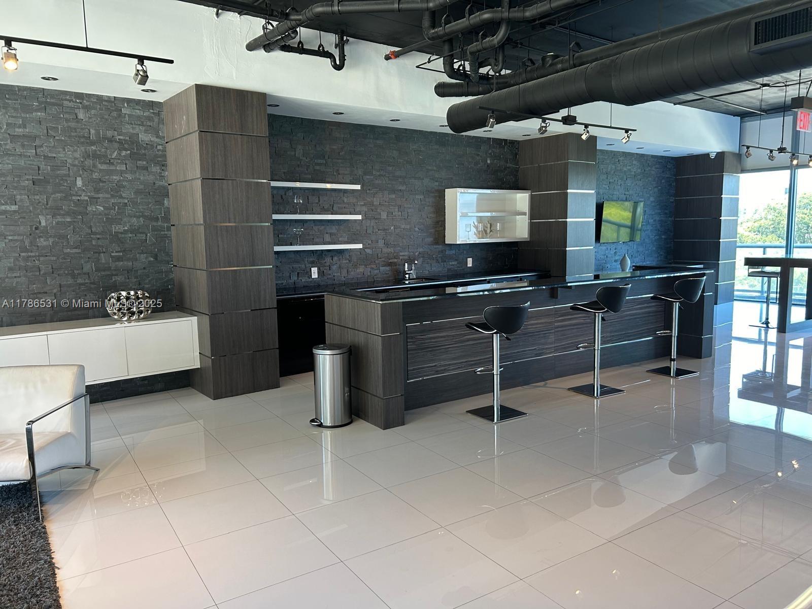 601 Northeast 36th Street, Unit 801 Miami, FL 33137 - Photo 16 of 24 a kitchen with a sink a counter and appliances