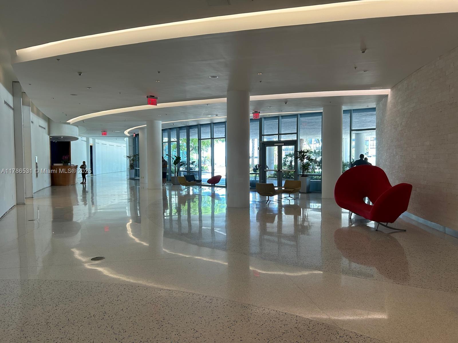 601 Northeast 36th Street, Unit 801 Miami, FL 33137 - Photo 22 of 24 a lobby with a table and chairs