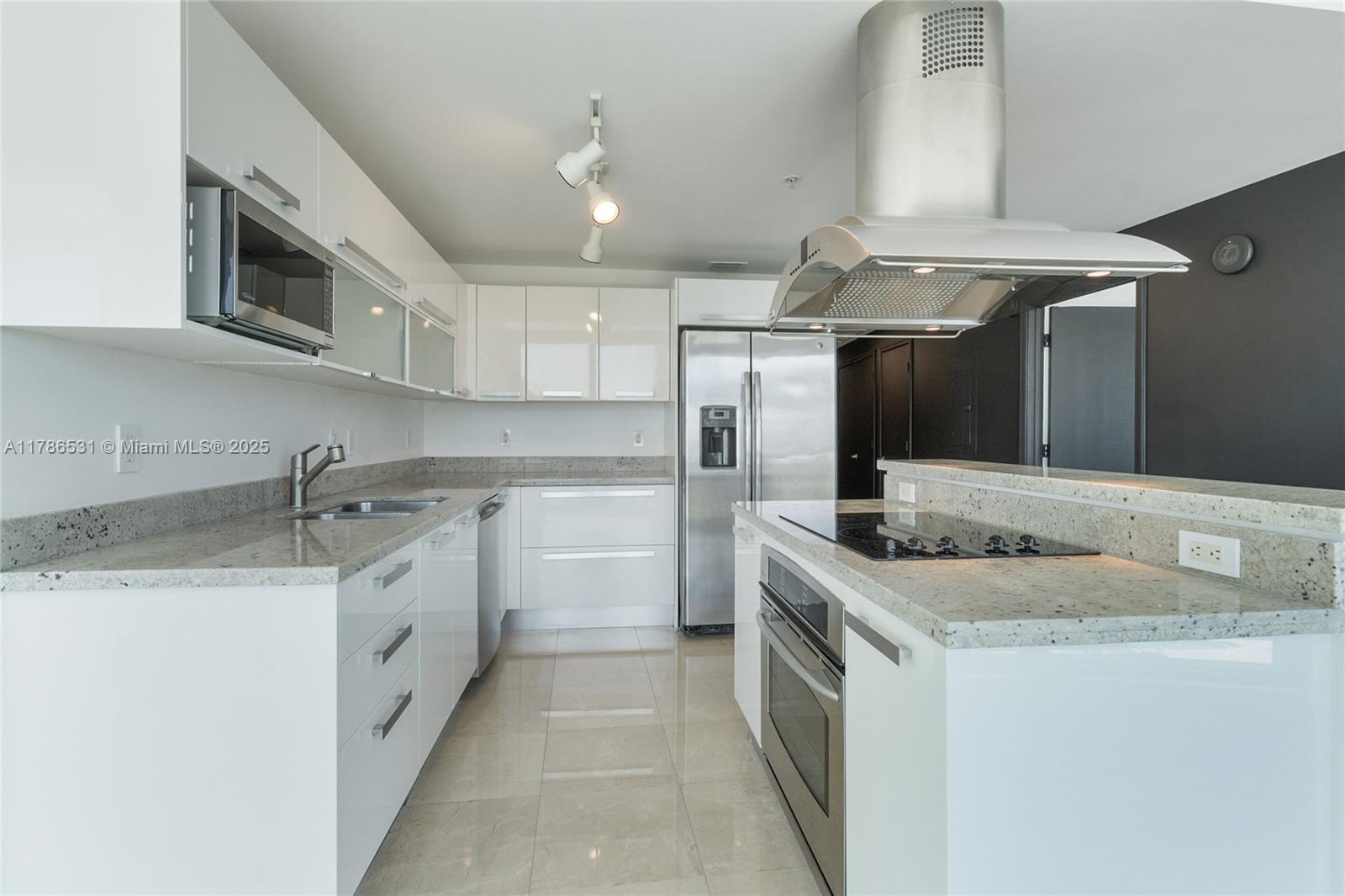 601 Northeast 36th Street, Unit 801 Miami, FL 33137 - Photo 6 of 24 a kitchen with stainless steel appliances granite countertop a sink and a stove