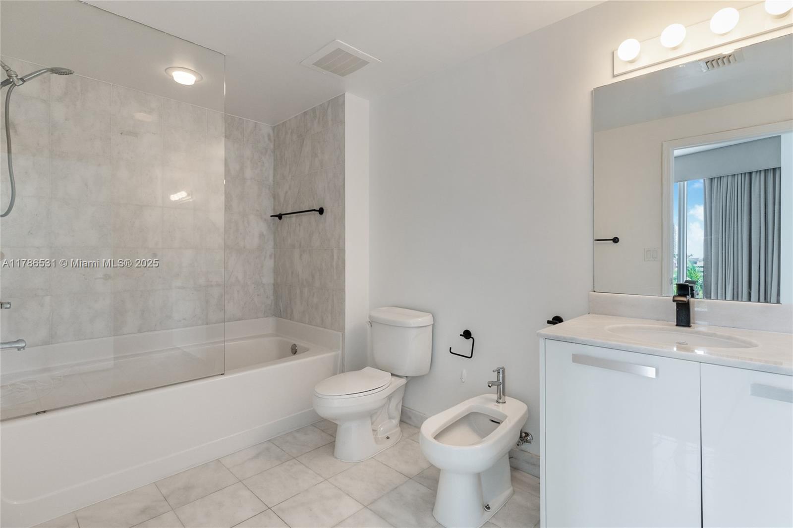 601 Northeast 36th Street, Unit 801 Miami, FL 33137 - Photo 10 of 24 a bathroom with a sink toilet and shower