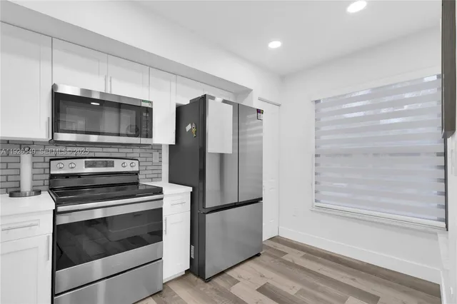 a kitchen with a stove microwave and refrigerator