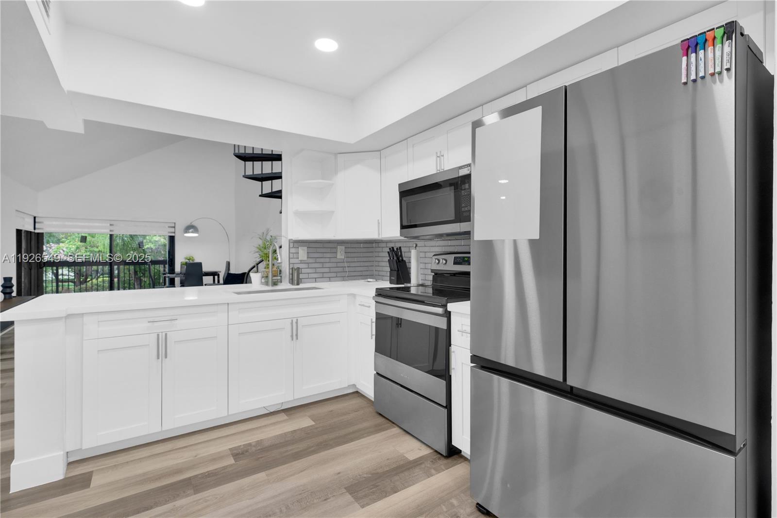 13028 Southwest 88th Lane, Unit A205 Miami, FL 33186 - Photo 15 of 37 a kitchen with stainless steel appliances a refrigerator sink and microwave