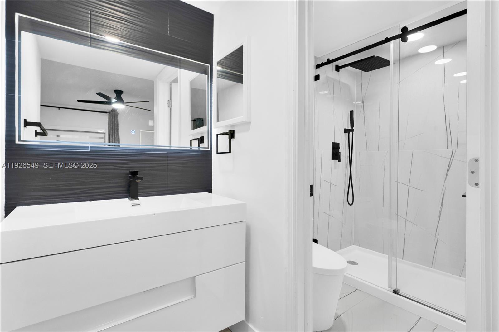 13028 Southwest 88th Lane, Unit A205 Miami, FL 33186 - Photo 19 of 37 a bathroom with a sink a toilet and shower