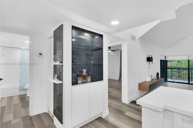 a open kitchen with white cabinets and stainless steel appliances