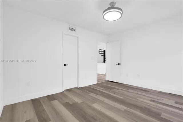 a view of a room with wooden floor