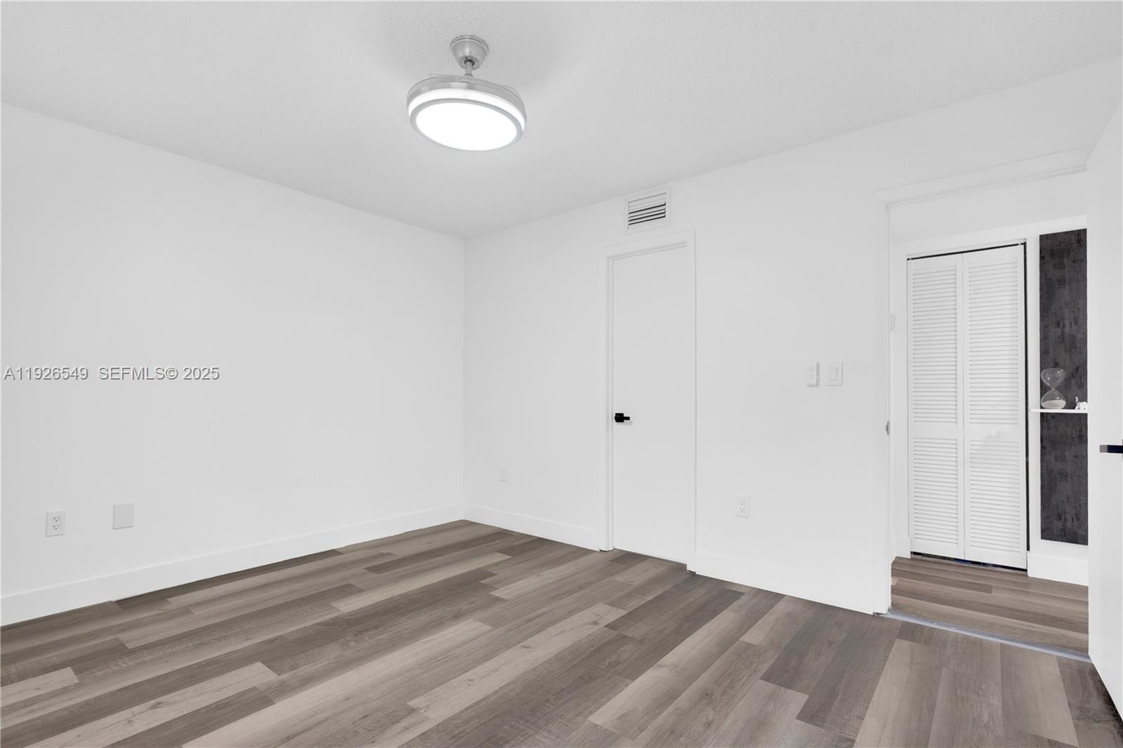 13028 Southwest 88th Lane, Unit A205 Miami, FL 33186 - Photo 26 of 37 a view of empty room with wooden floor