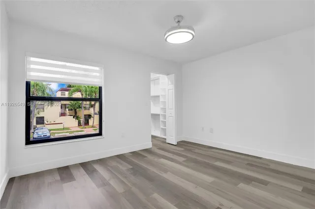 a view of a hallway with wooden floor and a fireplace